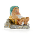 Sleepy fine bone china dwarf figurine with teal cap and yellow coat on gray stone base