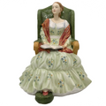 Seated Victorian-style lady figurine in floral dress with open book