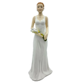Porcelain lady figurine in white gown holding yellow and green flowers