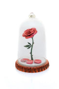 Decorative red rose under clear glass dome with ruffled brown base and small pink accents
