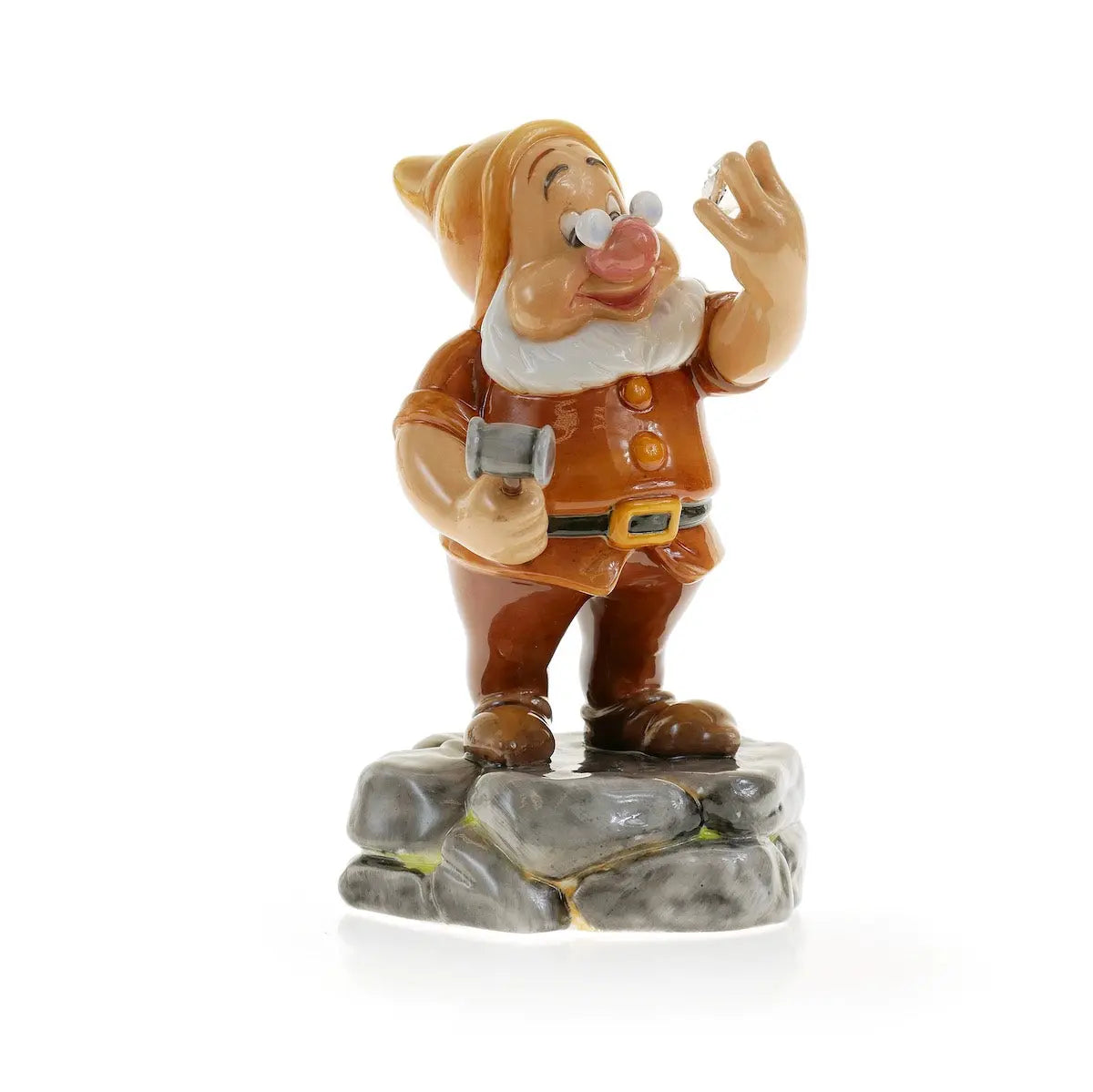 Fine bone china doc-style dwarf figurine with raised hands and gray rock base