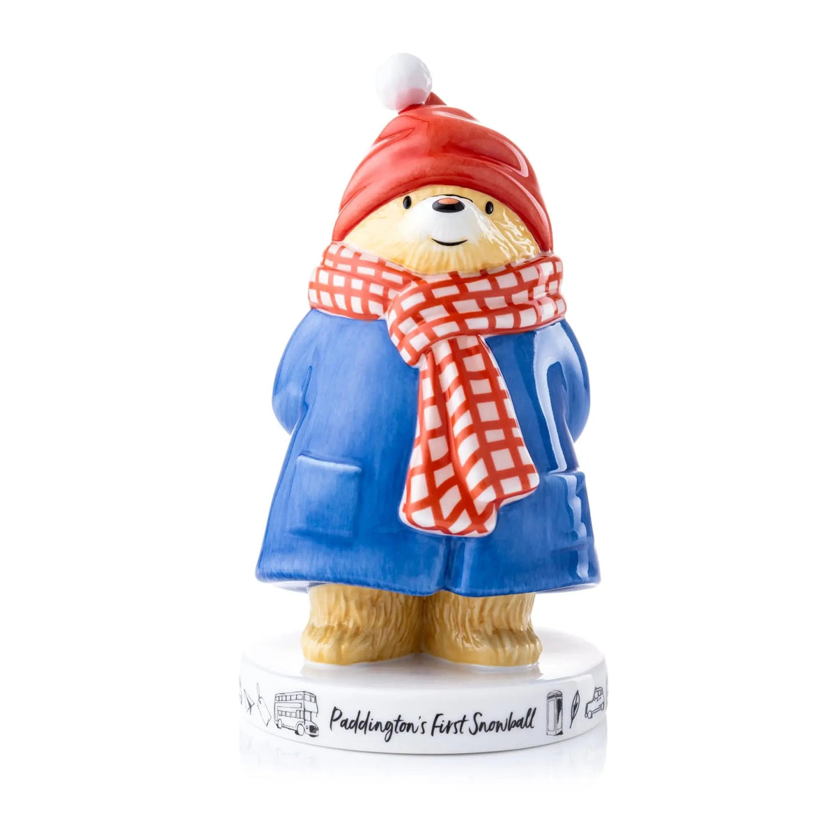 Ceramic Paddington-style bear figurine in blue coat, red hat, scarf, holding snowball