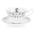 Fine bone china teacup and saucer set, white with blue floral band and character medallion