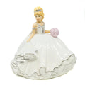 Mini bride porcelain figurine in white gown with pink bouquet, blonde headpiece