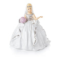 Porcelain gypsy doll figurine with blonde face, white gown, pink flower and veil