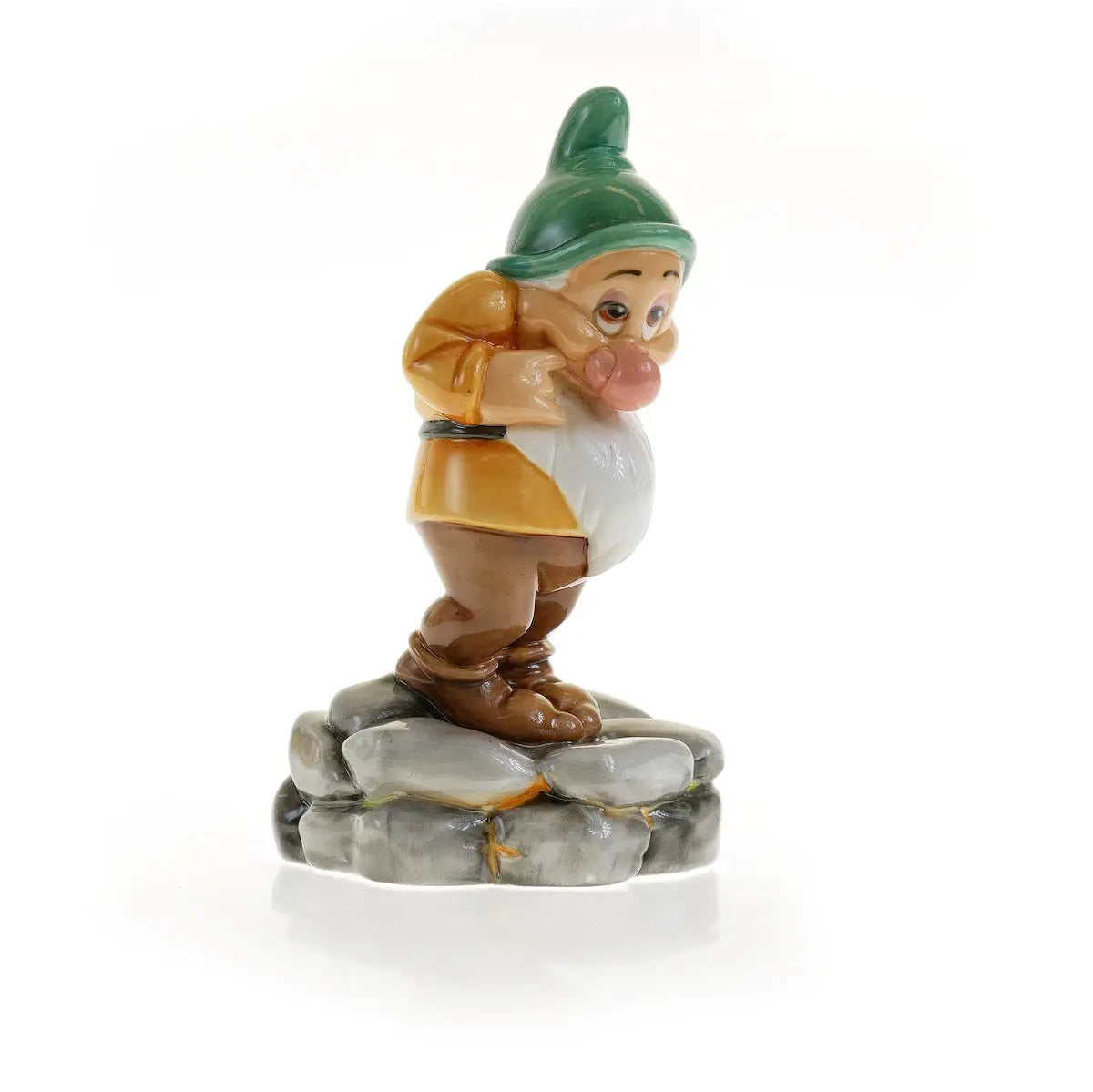 Fine bone china gnome figurine with green hat, orange tunic, standing on gray rock base