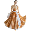 Porcelain ballerina figurine in an orange off-shoulder gown holding a white fan
