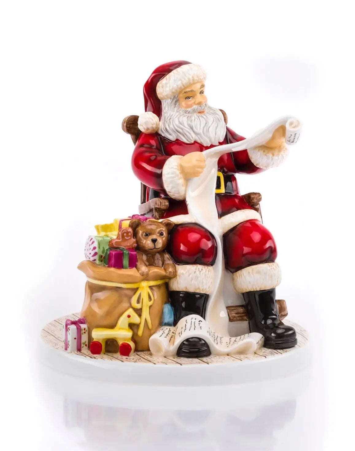 Santa Claus ceramic figurine in red suit with gifts, teddy bear, and toy rocking horse