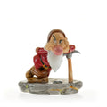 Grumpy dwarf figurine in fine bone china with red hood, white beard, holding pickaxe