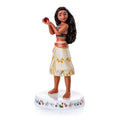 Porcelain figurine of a young woman holding a red apple on a floral base